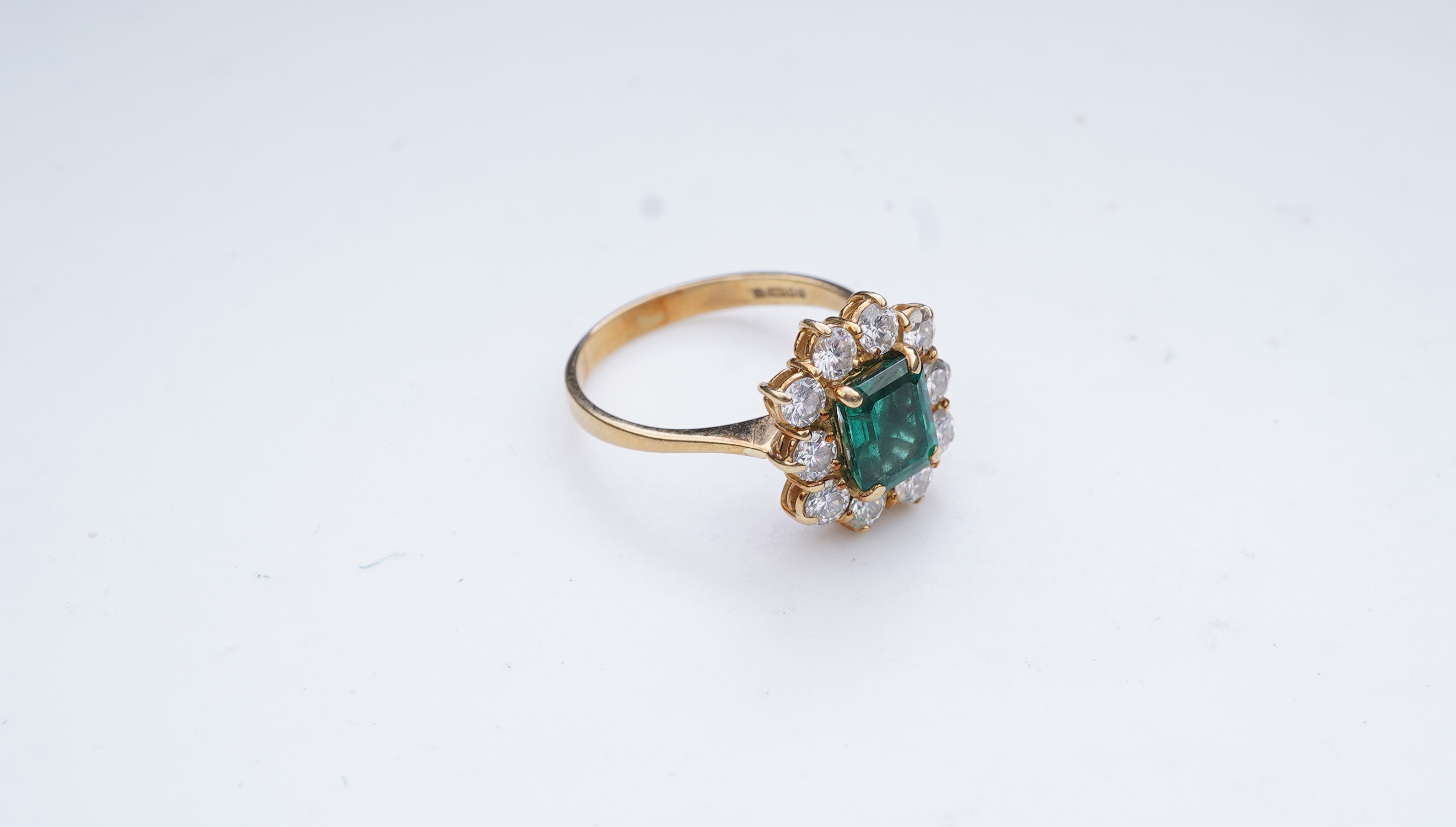 A synthetic emerald and diamond ring